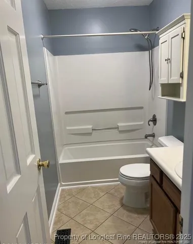 a bathroom with a sink a toilet and a shower