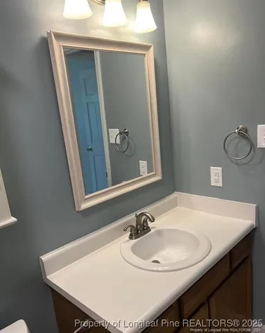 a bathroom with a sink a mirror and a toilet