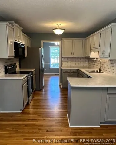 a kitchen with a sink and wooden cabinets