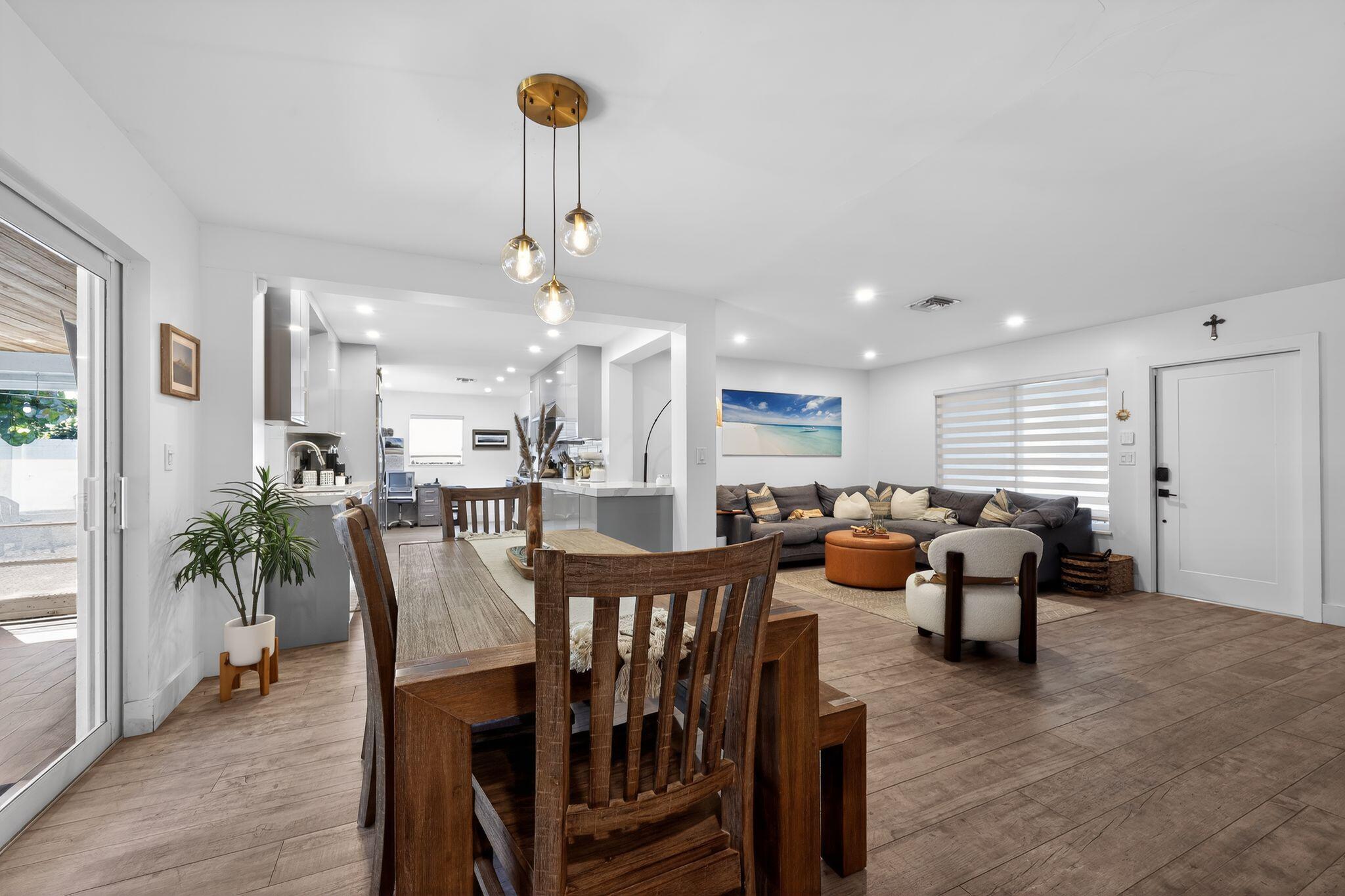 976 Southwest 11th Street Boca Raton, FL 33486 - Photo 17 of 29 a view of a dining room and livingroom with furniture wooden floor a chandelier