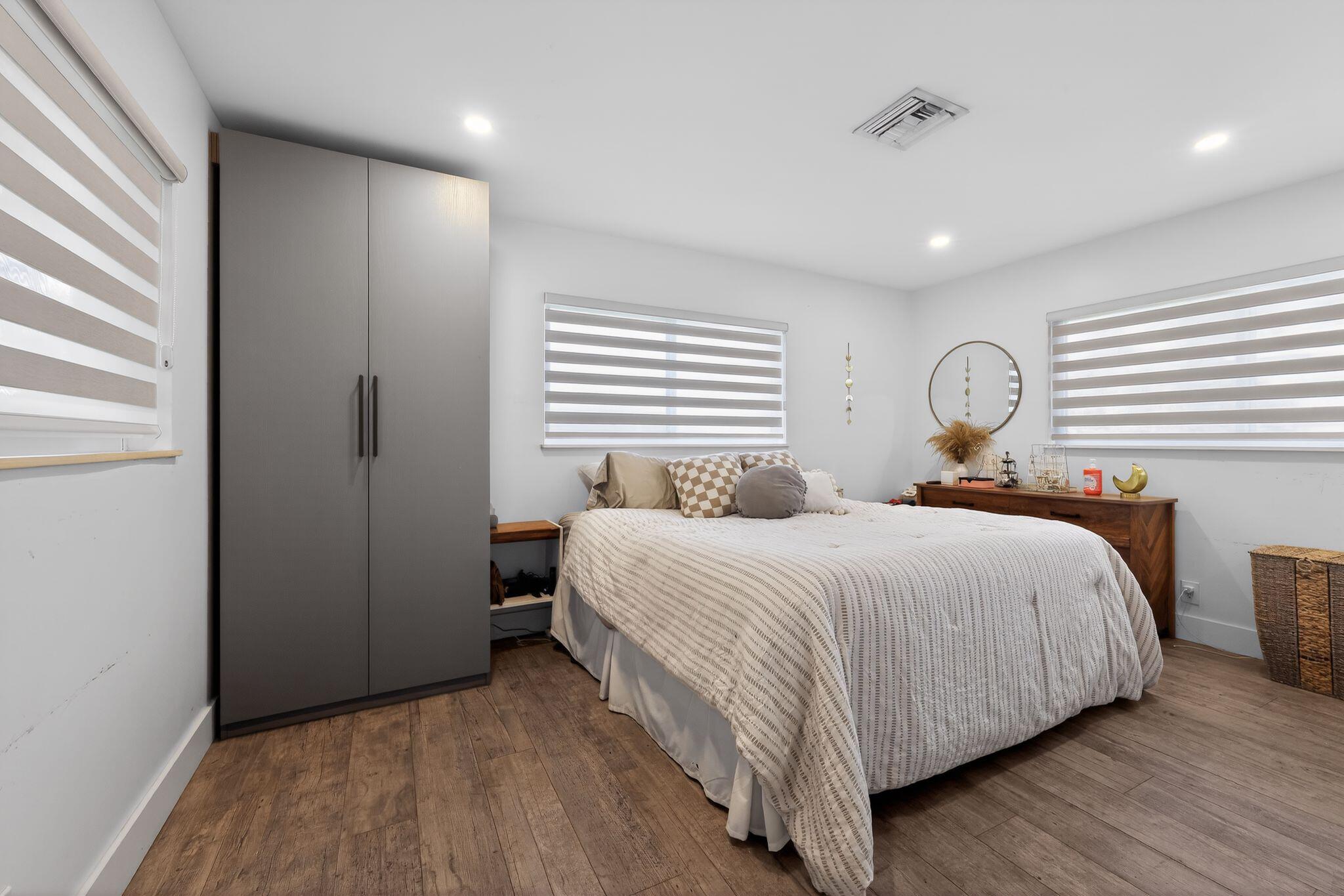 976 Southwest 11th Street Boca Raton, FL 33486 - Photo 20 of 29 a bedroom with a bed and a window