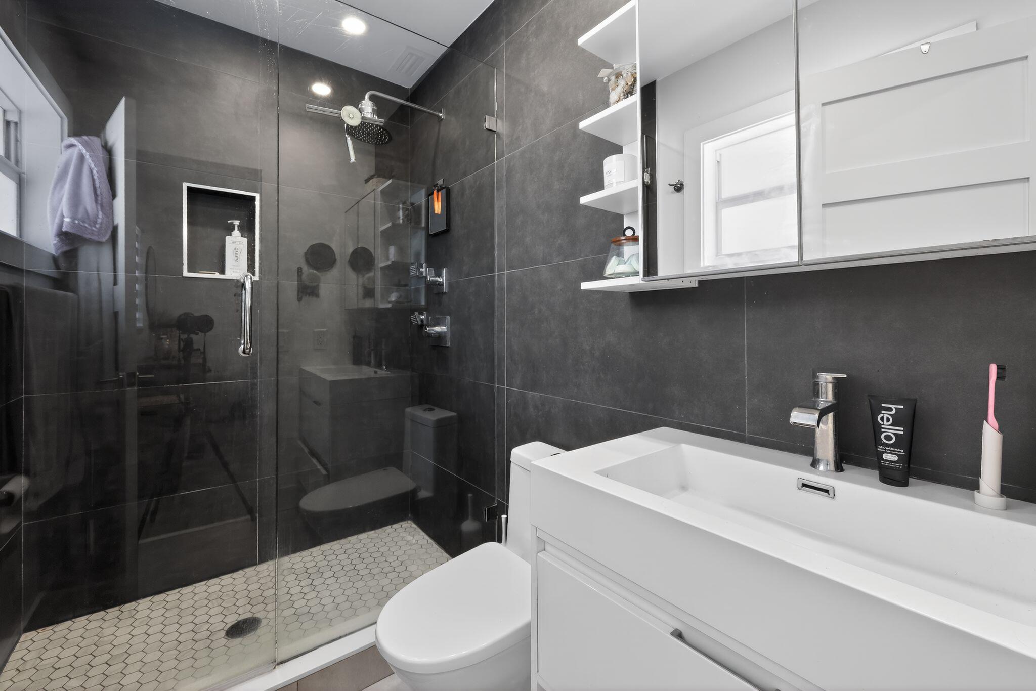976 Southwest 11th Street Boca Raton, FL 33486 - Photo 21 of 29 a bathroom with a sink a toilet and shower