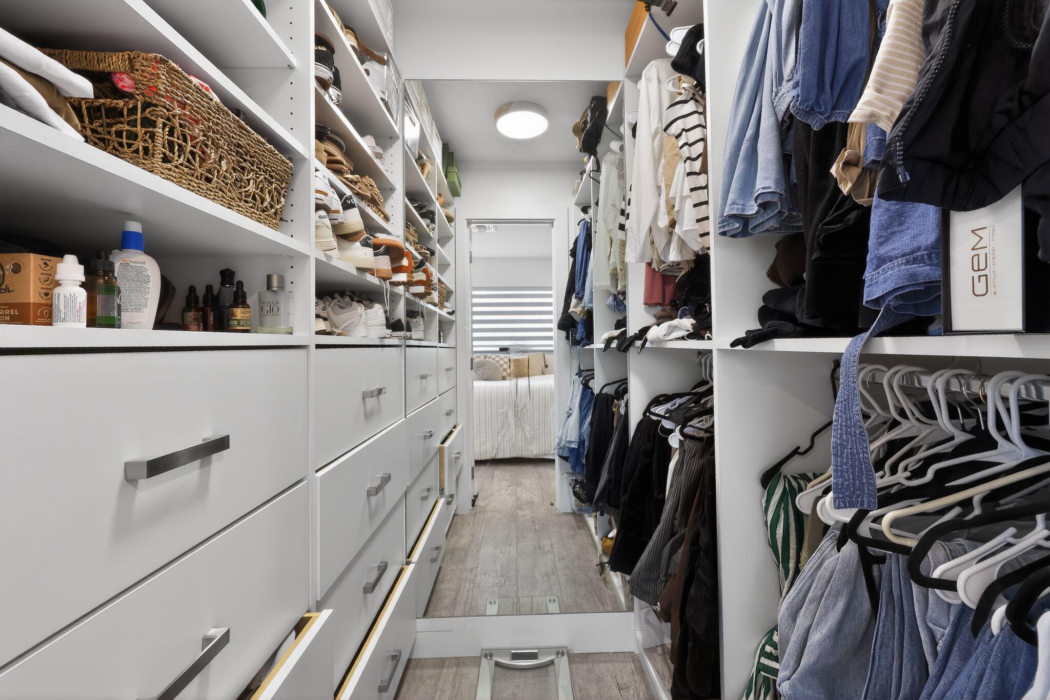 976 Southwest 11th Street Boca Raton, FL 33486 - Photo 22 of 29 a view of walk in closet with clothes and shoes