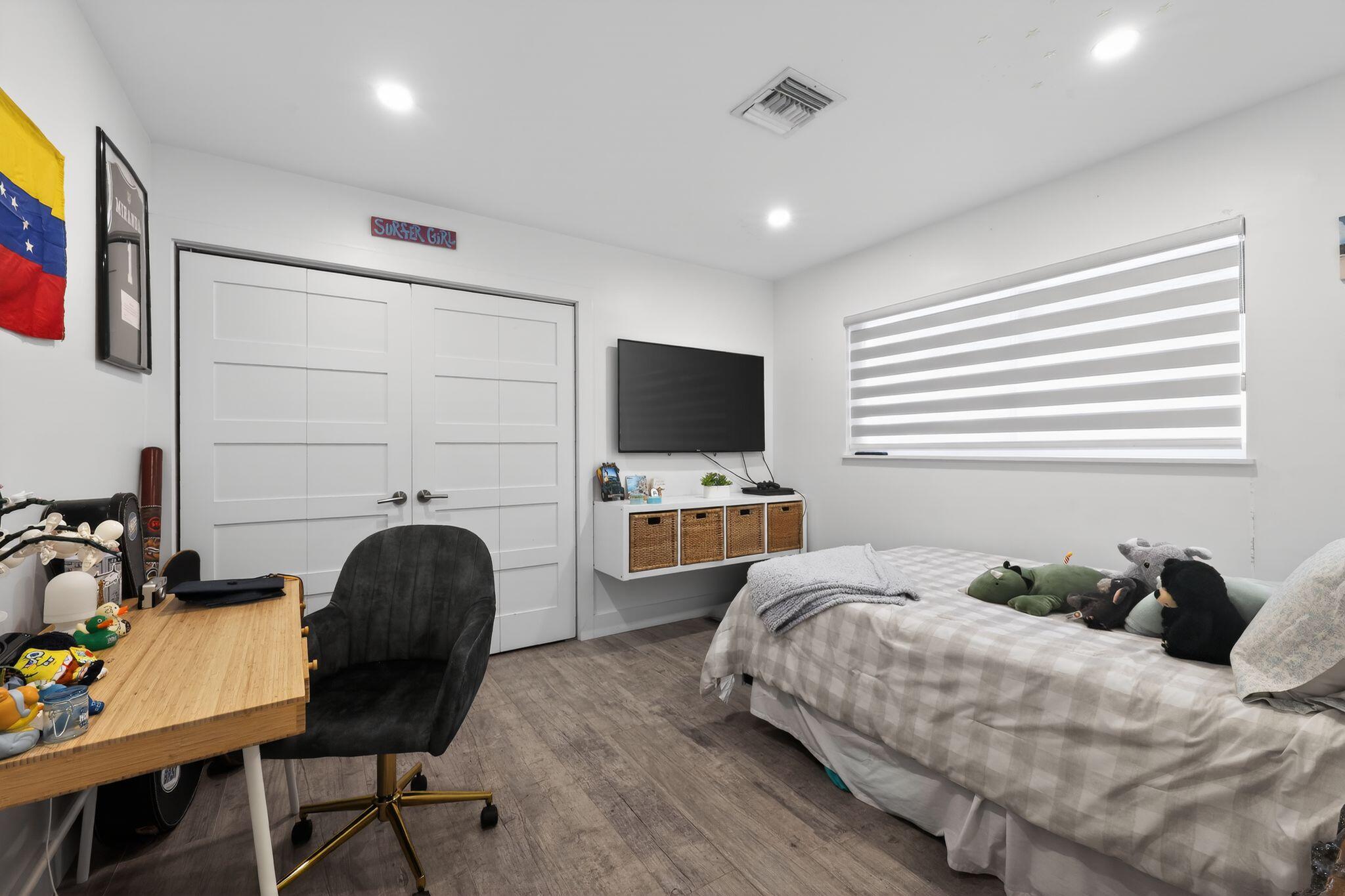 976 Southwest 11th Street Boca Raton, FL 33486 - Photo 25 of 29 a bedroom with a bed and a flat screen tv
