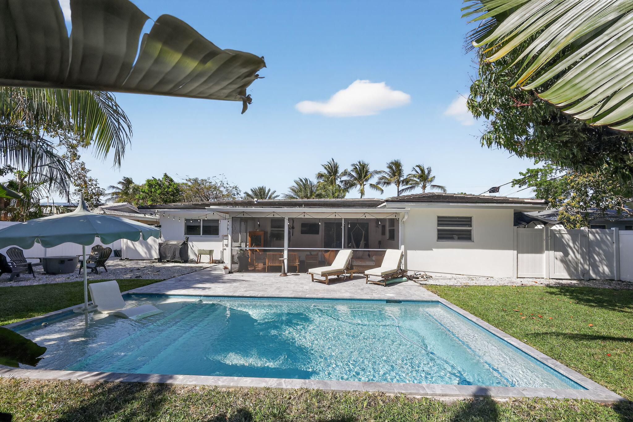 976 Southwest 11th Street Boca Raton, FL 33486 - Photo 5 of 29 a view of a house with a backyard and sitting area
