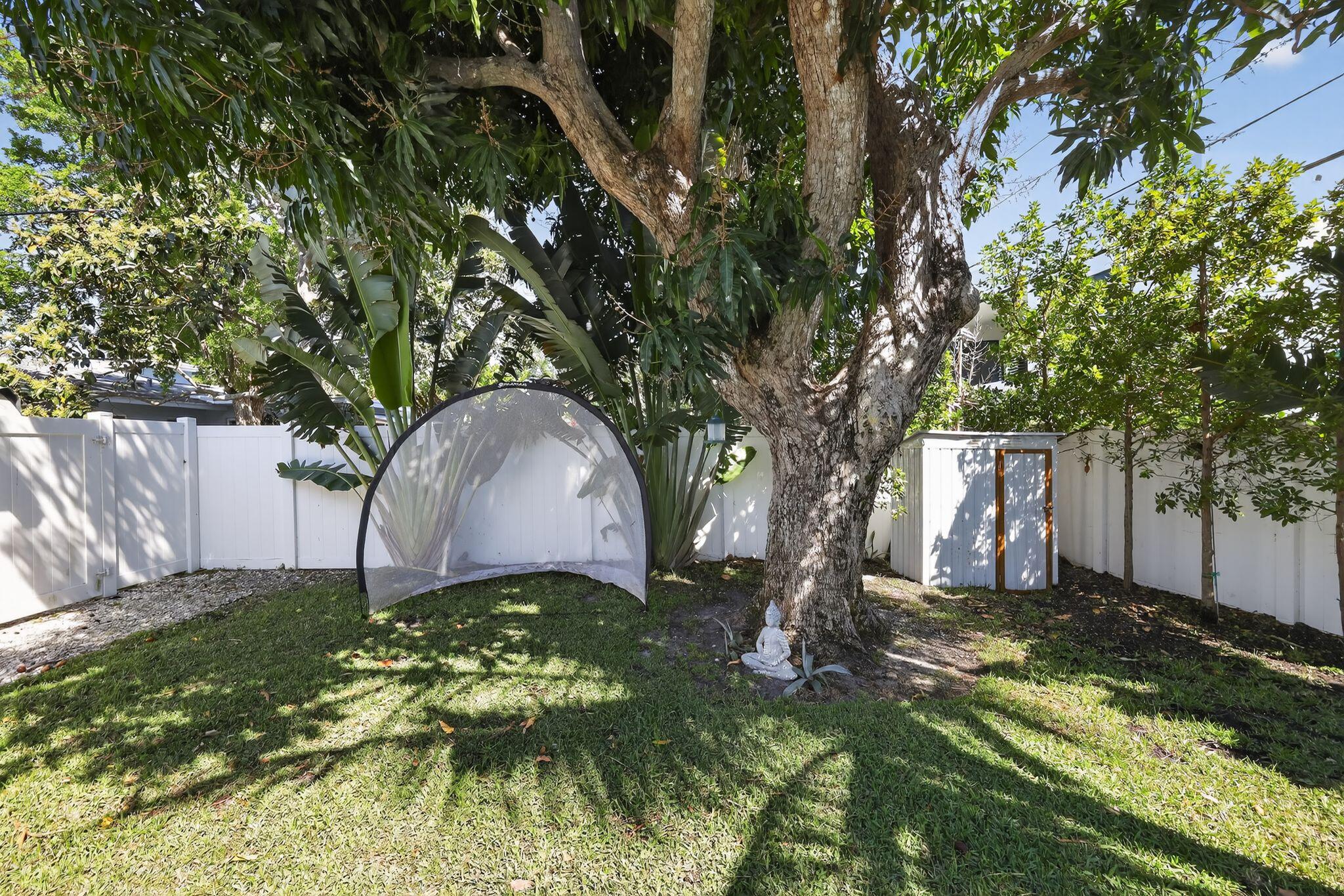 976 Southwest 11th Street Boca Raton, FL 33486 - Photo 8 of 29 a backyard of a house with lots of green space