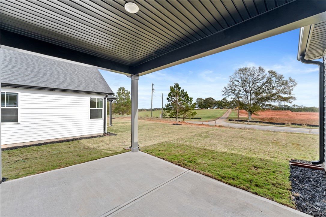 167 Tiger Lily Drive Anderson, SC 29621 - Photo 32 of 34 A spacious covered patio offers broad views of the surrounding rural landscape.