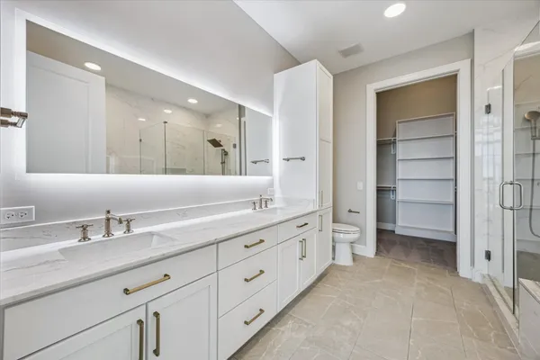 a bathroom with a double vanity sink and mirror