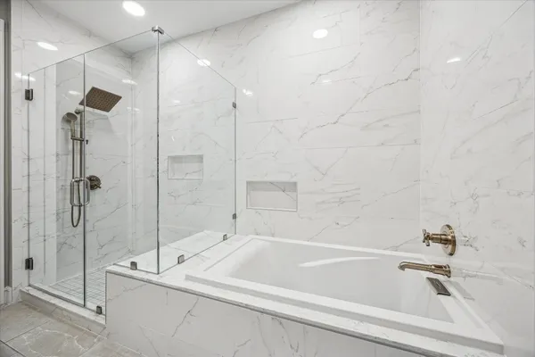 a bathroom with a bathtub and a shower