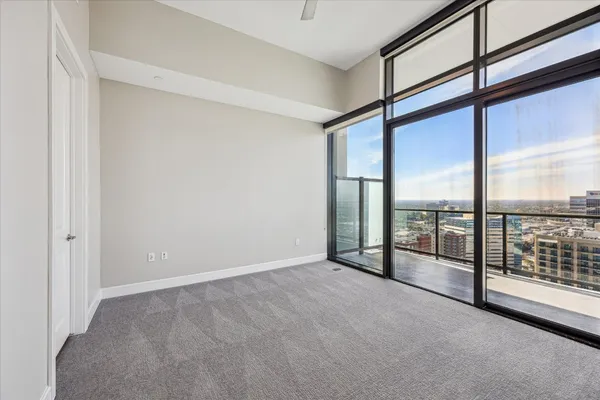 an empty room with sliding door and windows