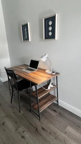 a bedroom with a bed and a flat tv screen on the dresser