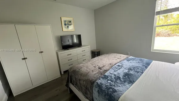 a bedroom with a bed and a night stand