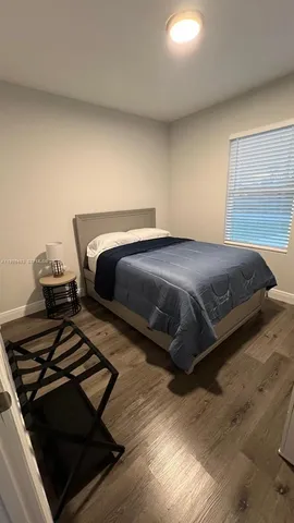 a bedroom with a bed and a television