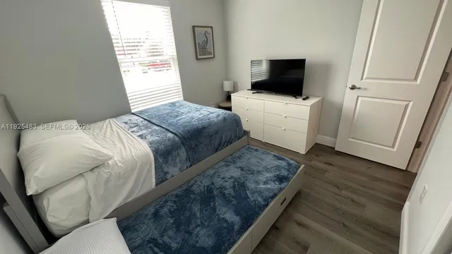 a bedroom with bed and window