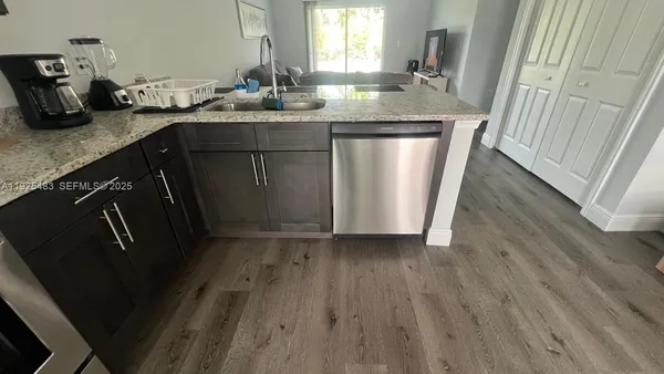 a kitchen with sink and refrigerator