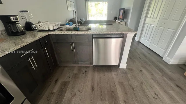 a kitchen with sink and refrigerator