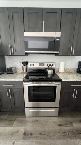 a kitchen with granite countertop a stove and a sink
