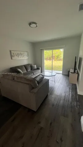 a view of a workspace with furniture and wooden floor