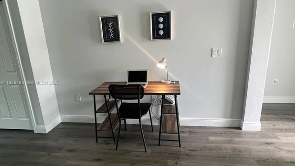a view of a workspace room with wooden floor and wooden floor