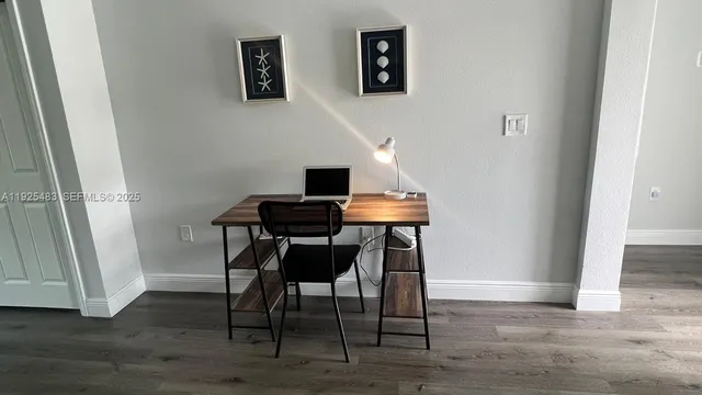 a view of a workspace room with wooden floor and wooden floor