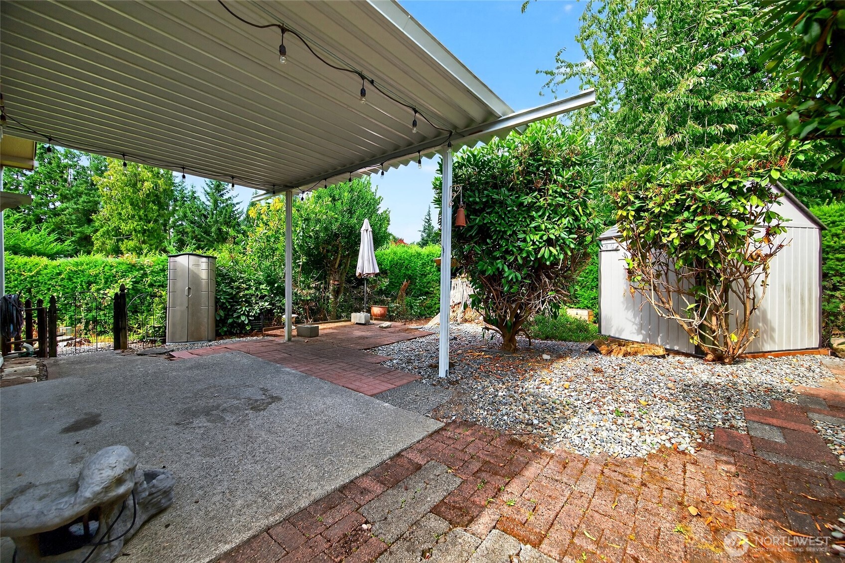 23825 15th Avenue Southeast, Unit 93 Bothell, WA 98021 - Photo 15 of 34 a backyard of a house with large trees and outdoor seating