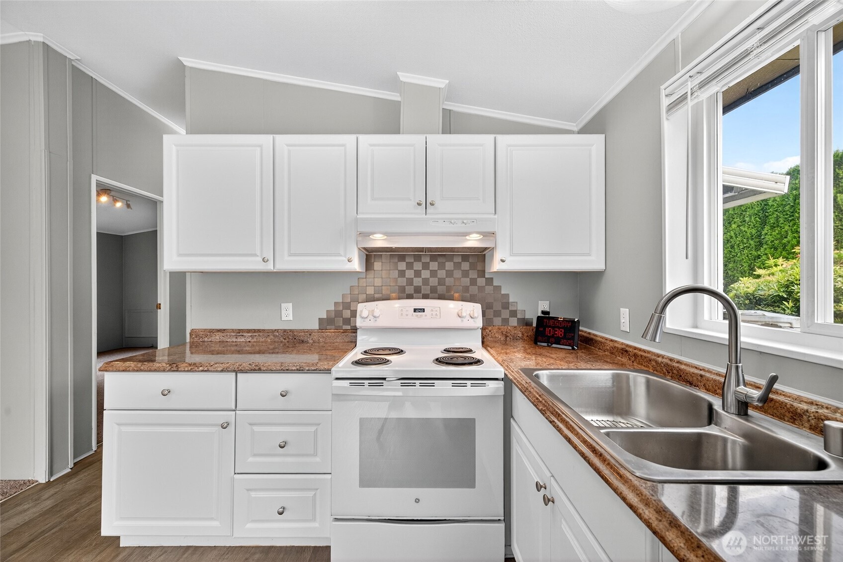 23825 15th Avenue Southeast, Unit 93 Bothell, WA 98021 - Photo 4 of 34 a kitchen with granite countertop a sink stove and cabinets