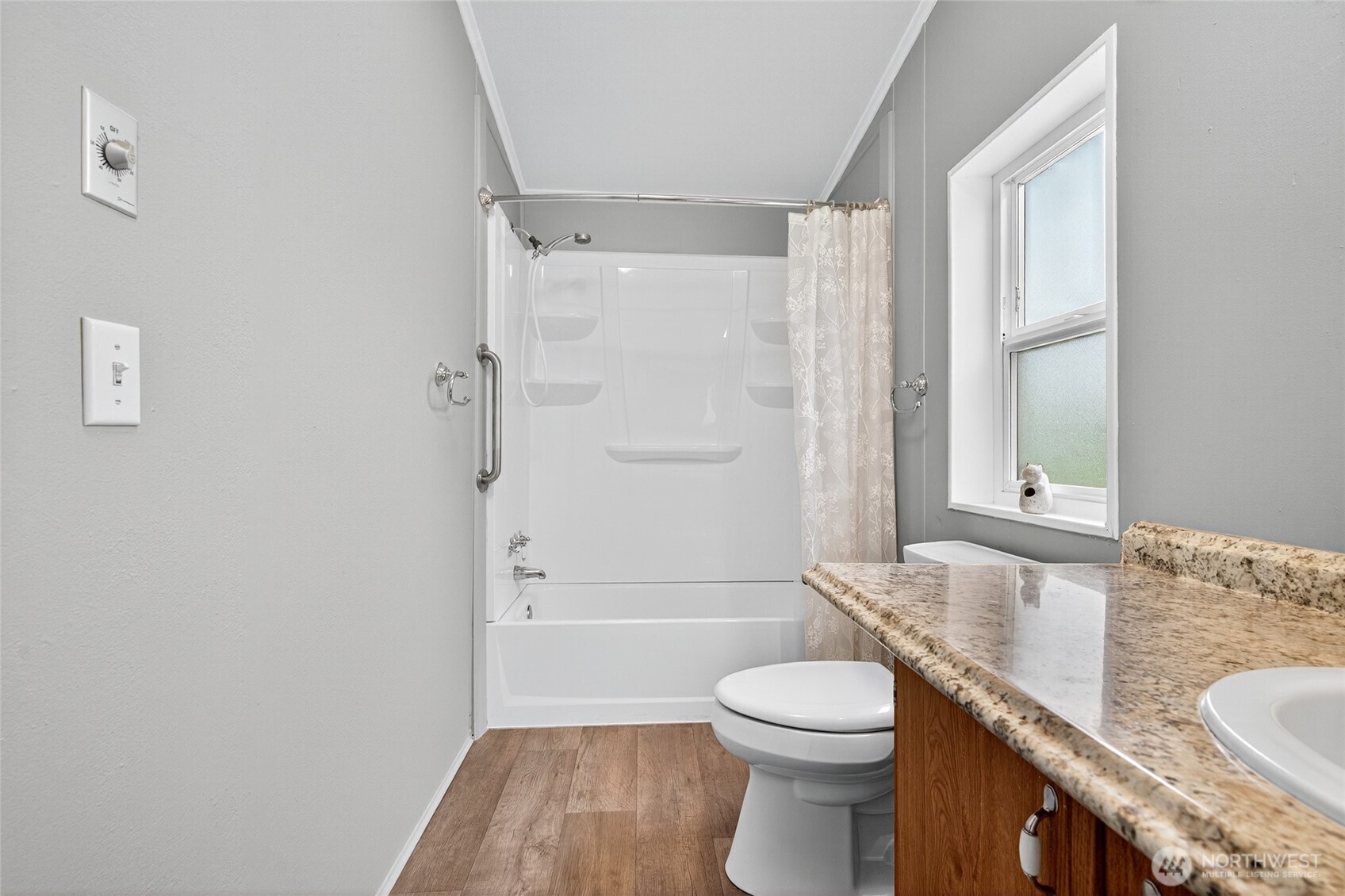 23825 15th Avenue Southeast, Unit 93 Bothell, WA 98021 - Photo 9 of 34 a bathroom with a granite countertop sink toilet a shower and a bathtub