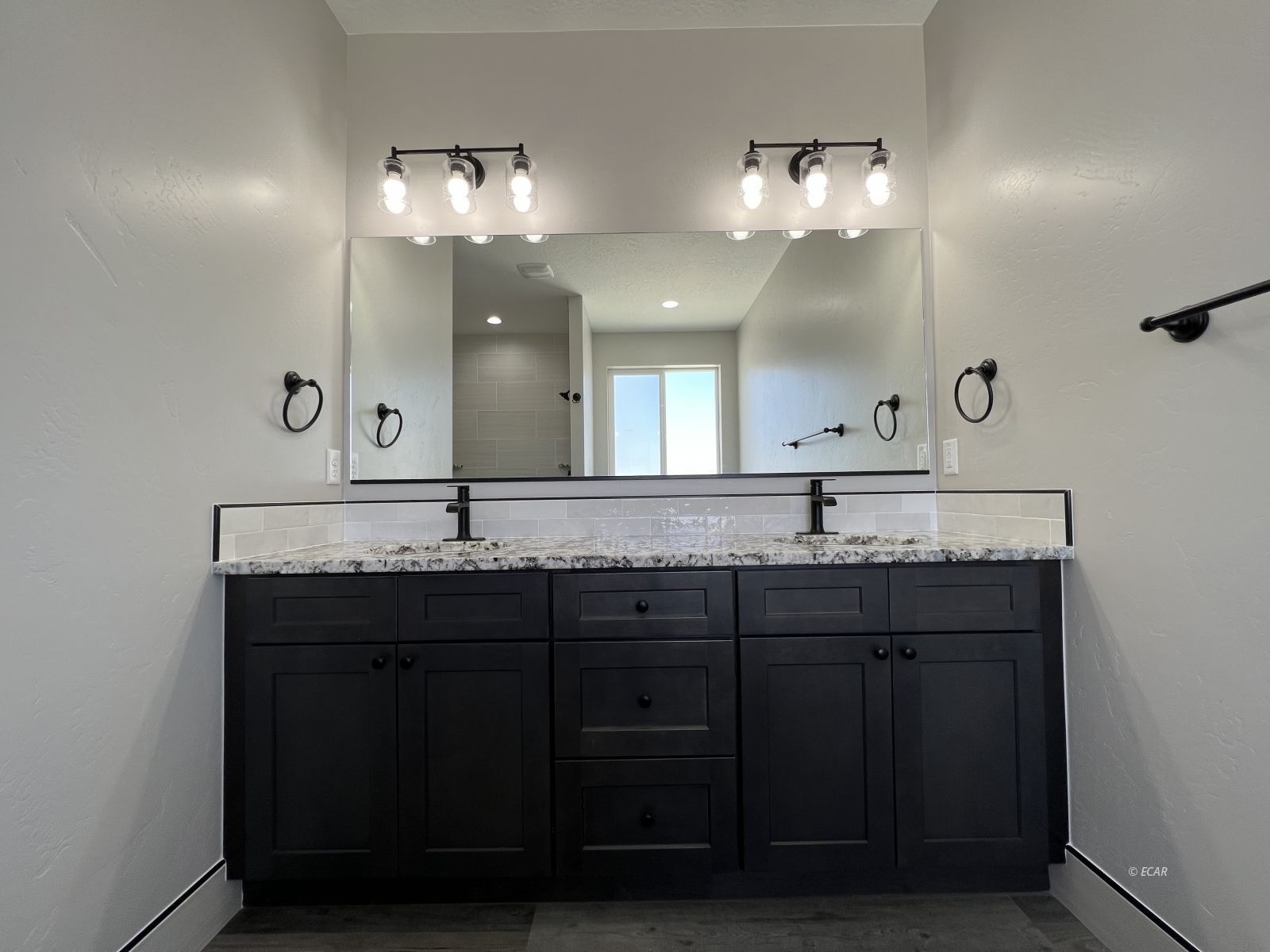 1265 Sun Vly Road Spring Creek, NV 89815 - Photo 28 of 34 a bathroom with a double vanity sink and a mirror