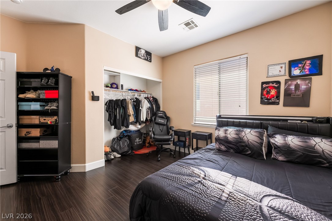 8358 Nelson Ridge Lane Las Vegas, NV 89178 - Photo 33 of 43 This naturally illuminated bedroom offers durable hardwood flooring and a convenient built-in closet for effortless organization.