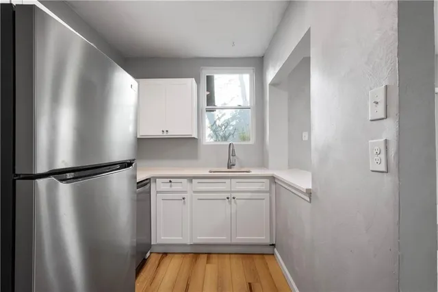 a kitchen with a refrigerator and a sink