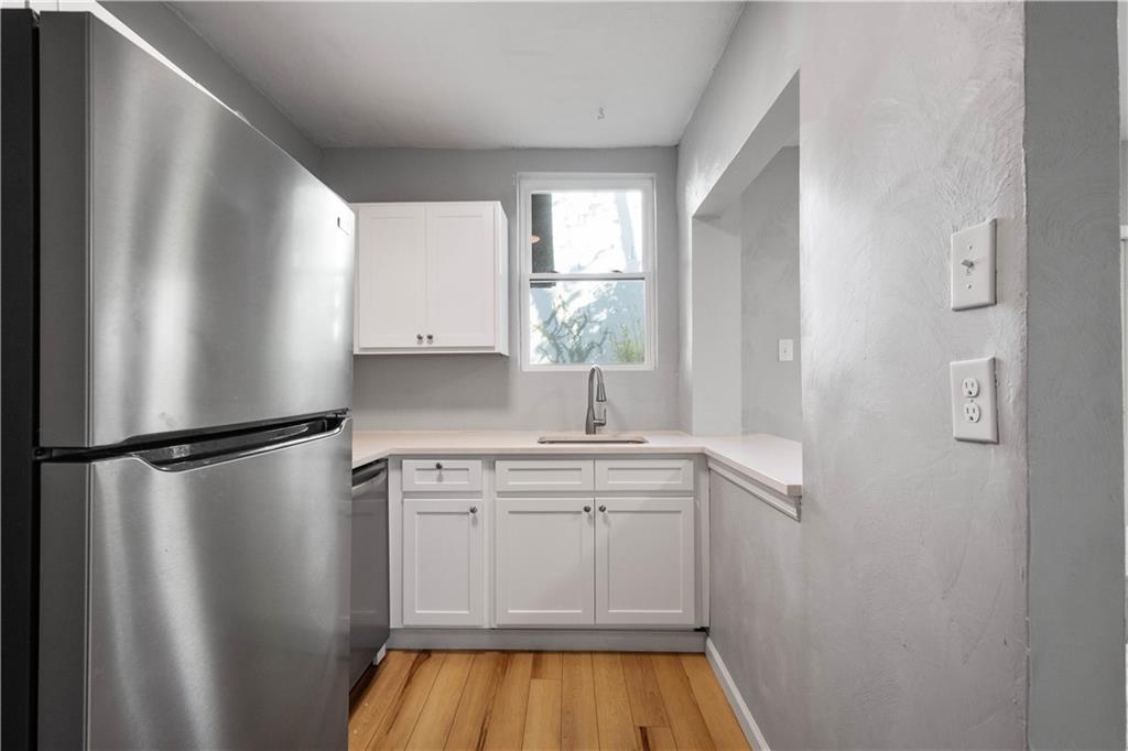 243 Castle Shannon Boulevard, Unit 243 Pittsburgh, PA 15228 - Photo 11 of 26 a kitchen with a refrigerator and a sink