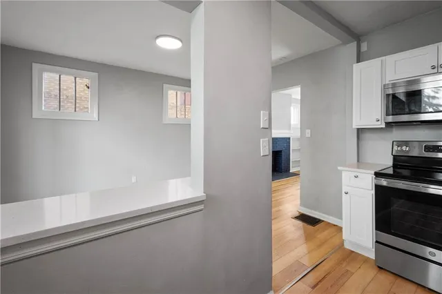 a kitchen with stainless steel appliances a refrigerator and a stove top oven