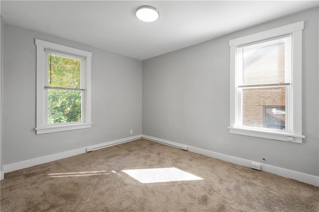 243 Castle Shannon Boulevard, Unit 243 Pittsburgh, PA 15228 - Photo 14 of 26 an empty room with windows