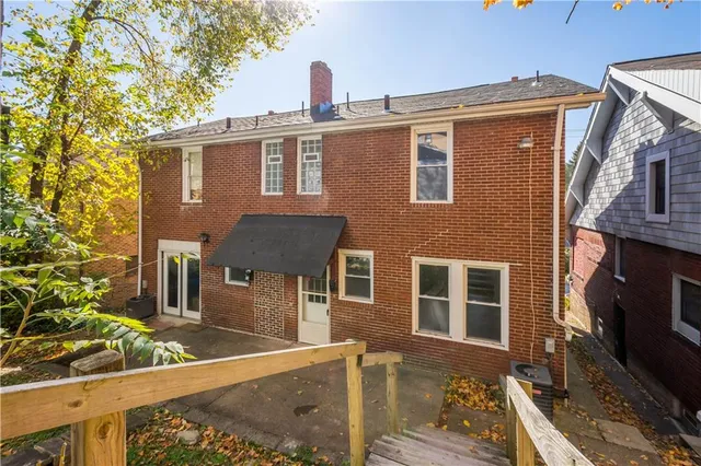 a front view of a house with large windows