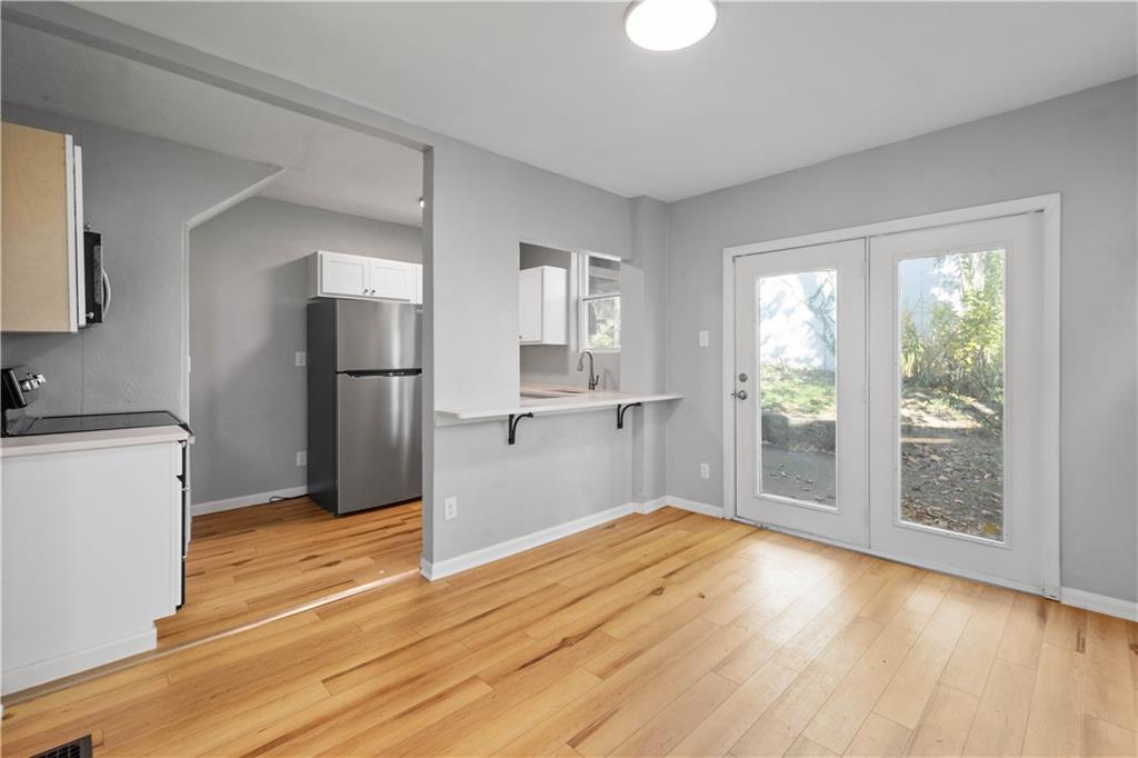 243 Castle Shannon Boulevard, Unit 243 Pittsburgh, PA 15228 - Photo 7 of 26 a view of empty room with wooden floor and window