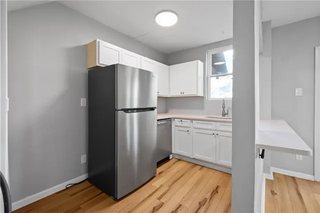 a kitchen with a refrigerator and a sink