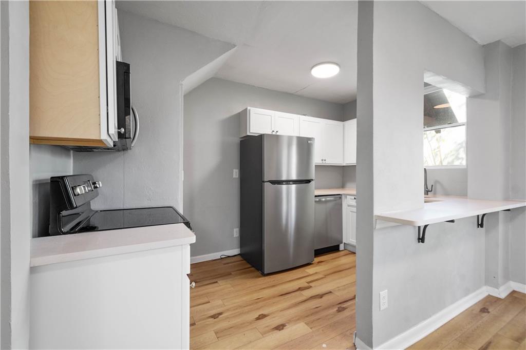 243 Castle Shannon Boulevard, Unit 243 Pittsburgh, PA 15228 - Photo 10 of 26 a kitchen with a refrigerator and a sink
