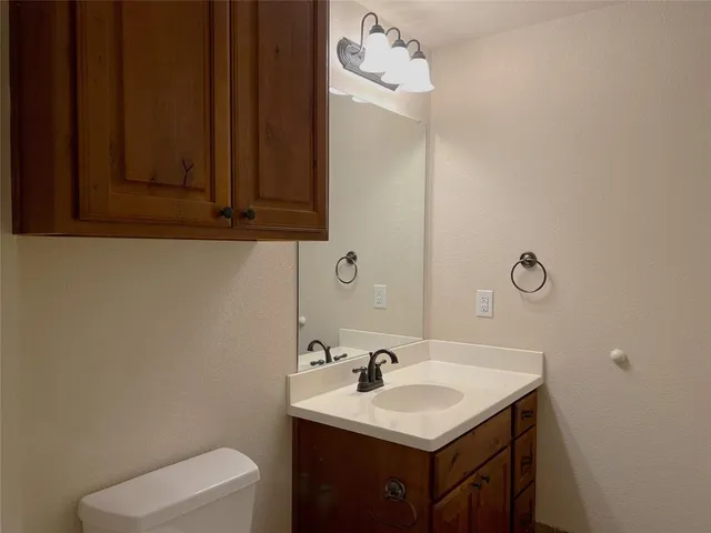 a bathroom with a sink a toilet and mirror
