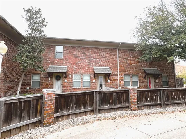 a front view of a house with a fence