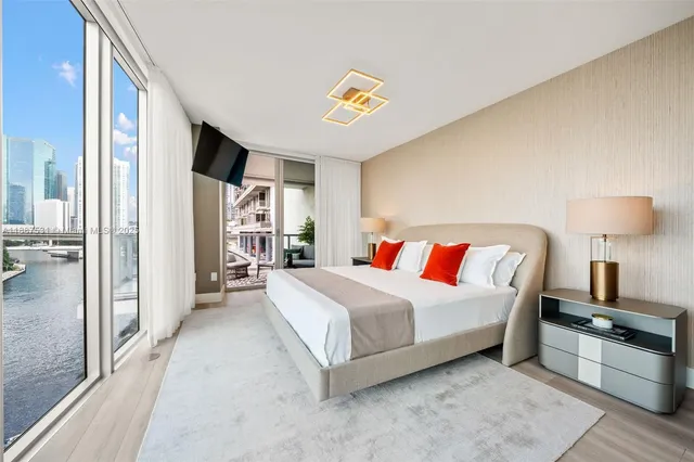 a spacious bedroom with a bed and large window