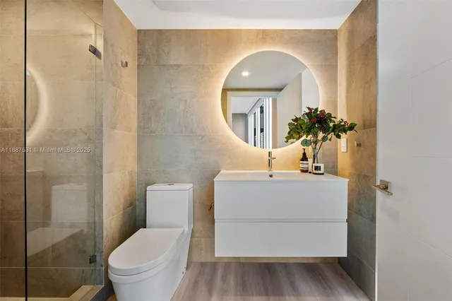 a view of walk in closet with clothes and white walls