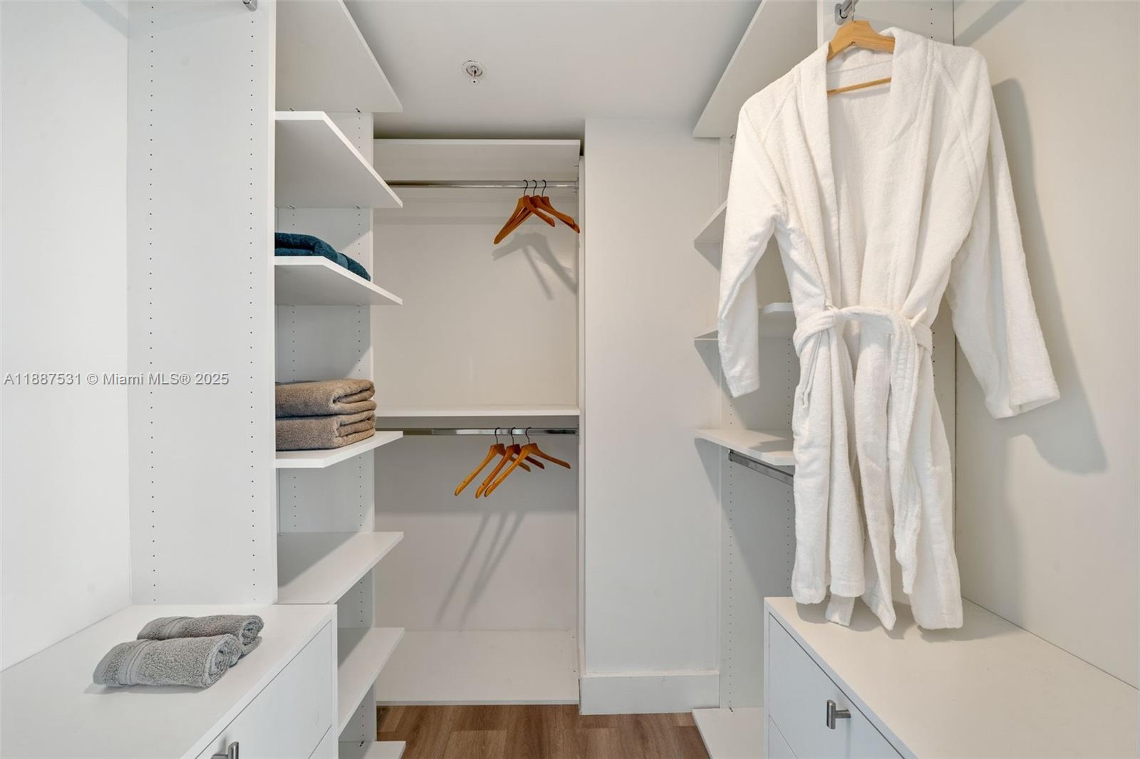 185 Southwest 7th Street, Unit 803 Miami, FL 33130 - Photo 17 of 25 a view of walk in closet with clothes and white walls