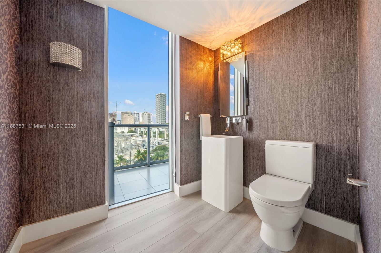 185 Southwest 7th Street, Unit 803 Miami, FL 33130 - Photo 19 of 25 a bathroom with a toilet and a shower