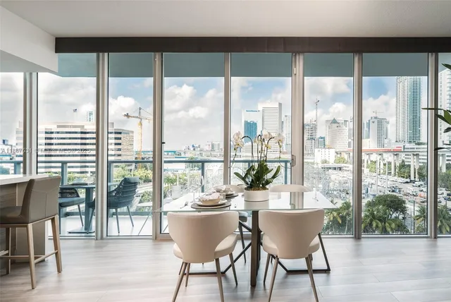 a dining room with furniture and wooden floor