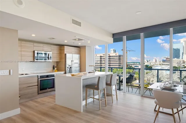 a kitchen with a table chairs and wooden floor