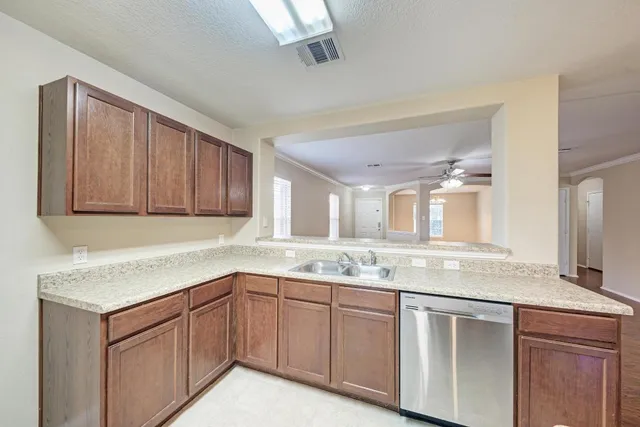 a kitchen with granite countertop stainless steel appliances sink and cabinets