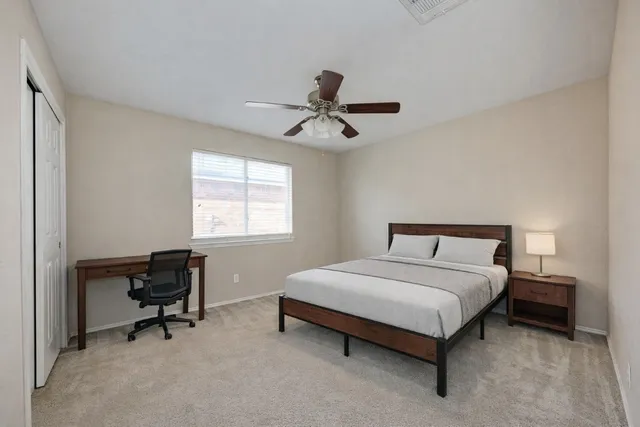 a bedroom with a bed and a window