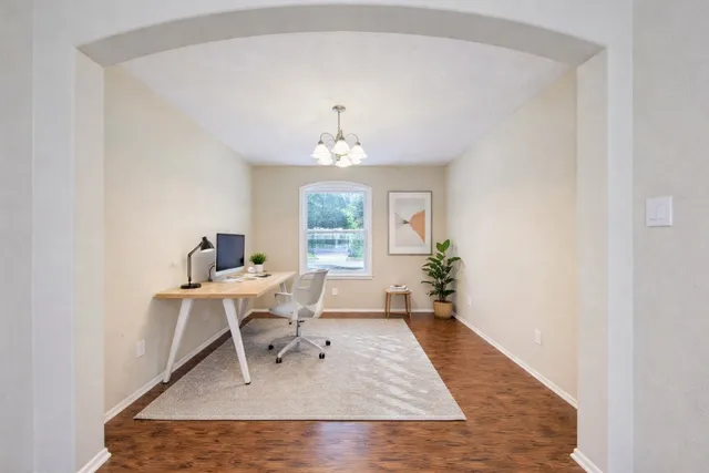 a work room with furniture and a chandelier