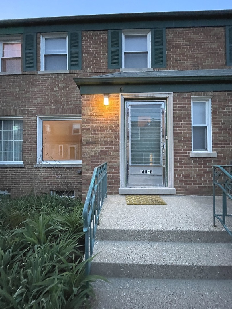 Undisclosed Address Oak Park, IL 60302 - Photo 1 of 15 a front view of a house with a garden and garage