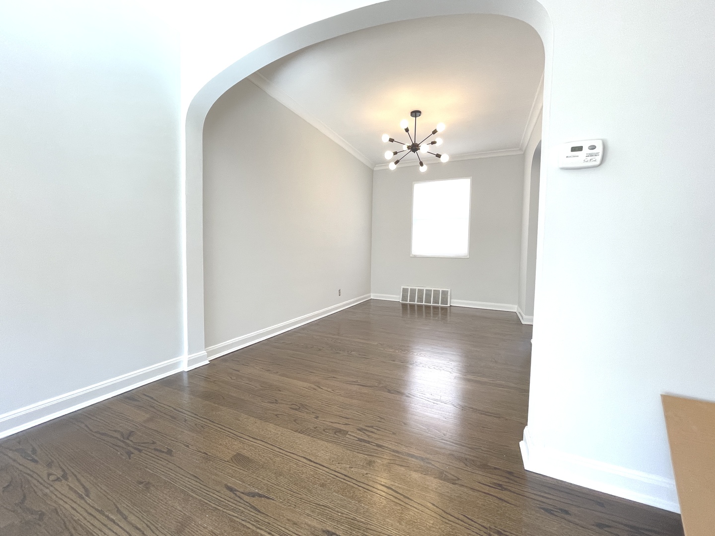 Undisclosed Address Oak Park, IL 60302 - Photo 9 of 15 a view of a room with wooden floor and chandelier